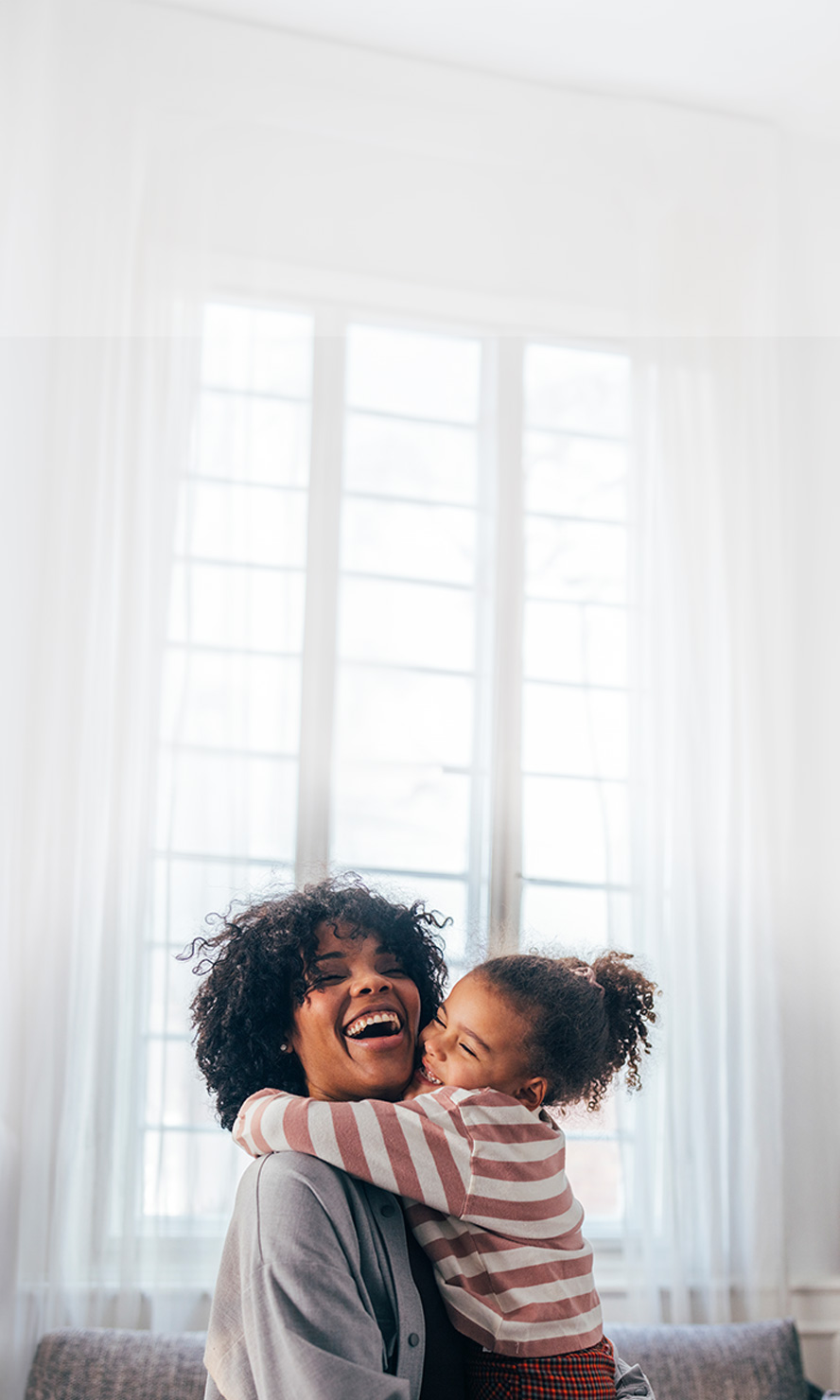 Mother and daughter sharing a joyous hug.