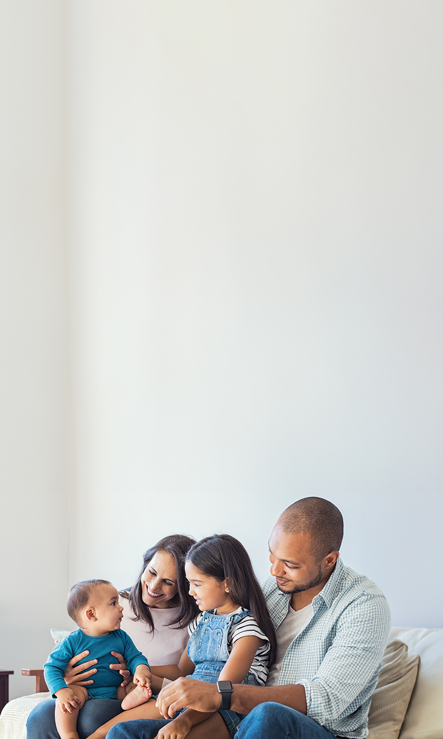 A family sitting on a couch.