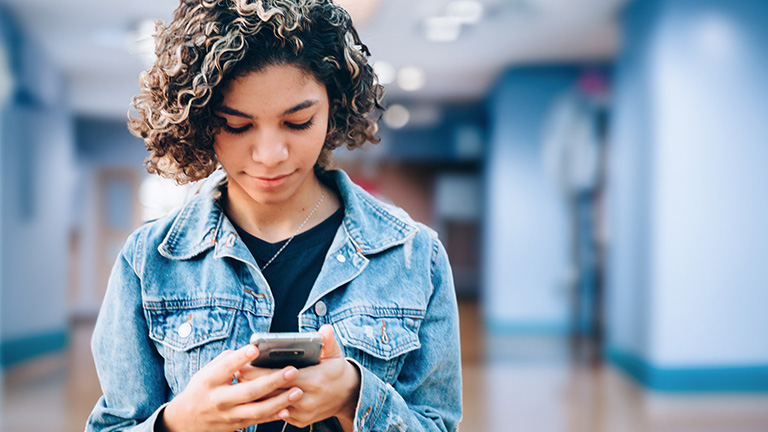 female teenager on cellphone