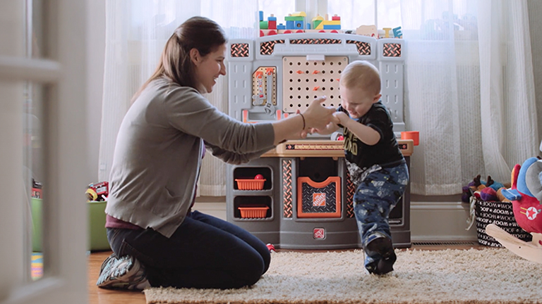 Mother helping her child use a foot abduction brace.